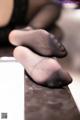 A pair of black stockings sitting on top of a table.