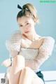 A woman sitting on top of a white table.